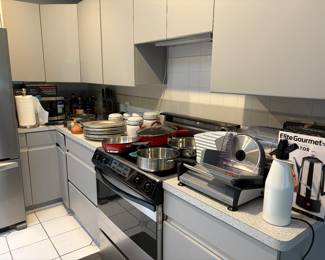 Pots pans, small kitchen appliances, microwave, paper towel holder and more.