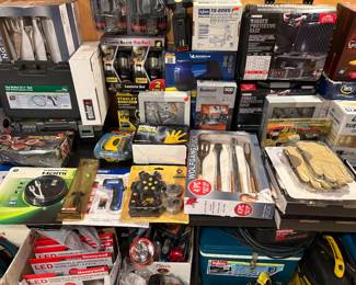 Brand new Igloo cooler. New in box Wolfgang Puck grilling set. New in box protective hard plastic case. Sony Walkman, Bushnell head lamp, Michelin portable air compressor and so much more.