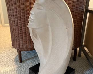 Decorative floor art. Women's bust on a black pedestal.