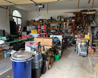 Garage is packed with tools and equipment all for sale.