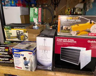 Rain train, food dehydrator, new in box chandelier, new in box gas chainsaw, craftsman tools.