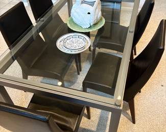 7 piece modern dining room glass top table with 6 leather chairs.