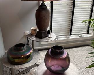 Multiple unique home decor items from iridescent glass items to table lamps.