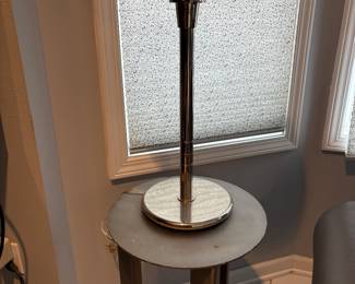 Metal side table and chrome table lamp with oval glass bulb.