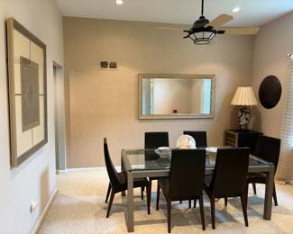 Beautiful dining room furniture in this home. Tables, wall art, lamps, mirror and beverage fridge are available for sale.