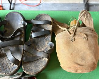 Vintage Vietnam War memorabilia. Army sandals and canteen in canvas bag.