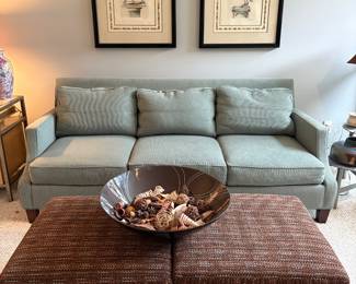 Living room furniture for sale. Mint Green upholstered couch, two brown upholstered ottomans, wall art and home decor.