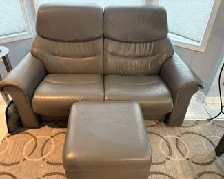 Gray leather loveseat with ottoman.