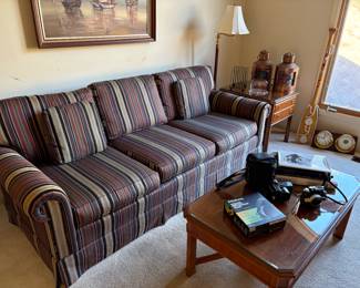 Three cushion couch in excellent condition, coffee side table, lamps, and cameras