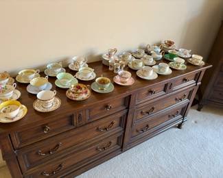 Long dresser with six drawers shown with a beautiful collection of China tea cups, and saucers