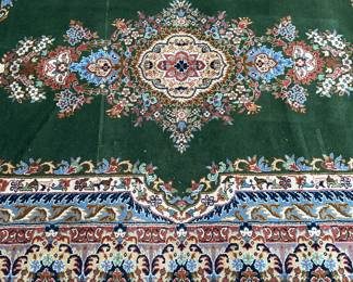 Green, blue, pink, red, gold area rug (111” x 73”)