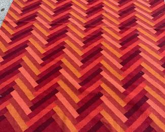 Red and orange zig zag stripe area rug (92” x 68”)