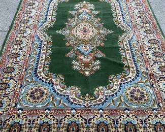 Green, blue, pink, red, gold area rug (111” x 73”)