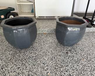 A pair of terra-cotta heavy matching planters.