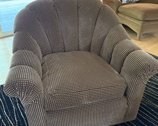 A pair of tufted swivel chairs. 