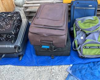 Lots of luggage, including a large black Tumi suitcase