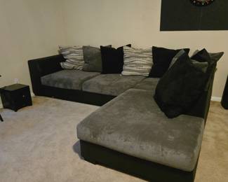 Large L shaped chase couch. Black, grey, comes with original pillows and still looks brand new. Bought from Ashley furniture and kept indoors. Pet free and smoke free environment.  Can seat up to 8 comfortably. Dart board with darts is also for sale!