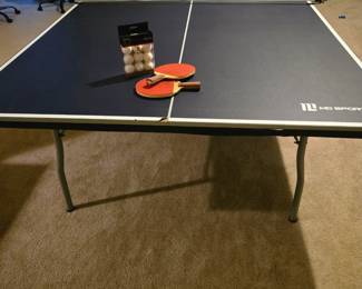 Like new ping pong gaming table. Has wheels although never moved. Four paddles and set of balls. Net in the center and ready to set up and play! It folds easily and transitions very smoothly from folded to game ready 