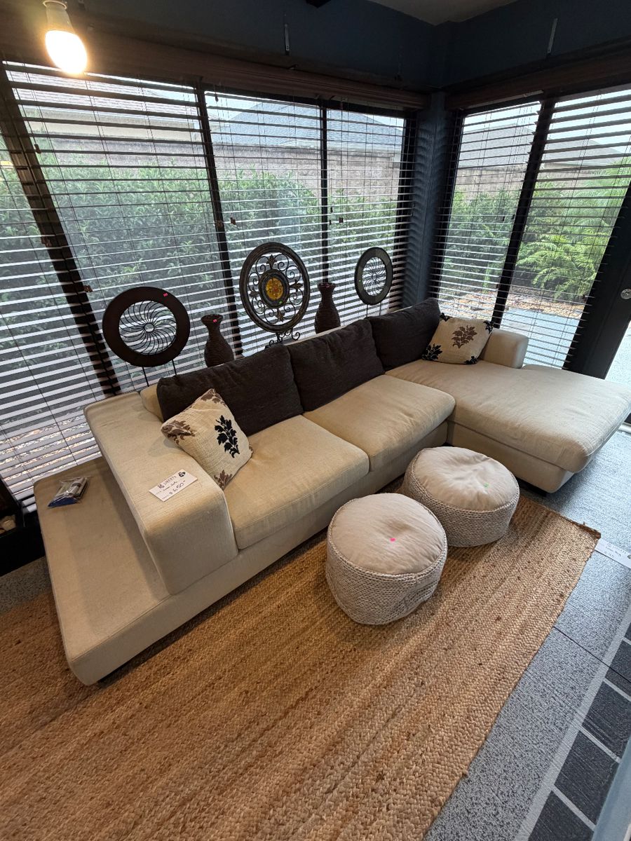 Unique off-white sofa with a built-in storage unit—like having a sofa table perfectly integrated