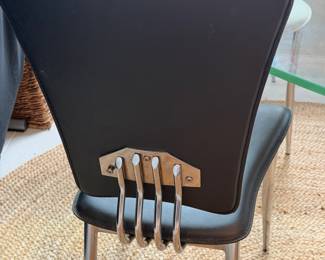 Mid-century modern glass-top dining table and chairs add a stylish touch