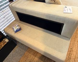 Unique off-white sofa with a built-in storage unit—like having a sofa table perfectly integrated