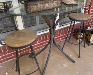 Fantastic artfully made wrought iron table and 2 barstools 