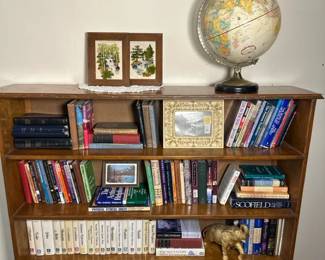 Vintage Wooden Bookshelf with Decorative and Literary Collection