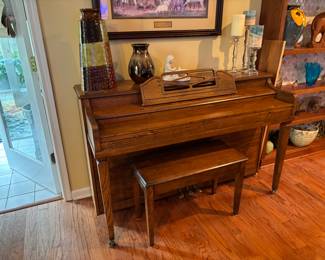 Wurlitzer upright piano with matching bench      dark colored glazed vase      decorative candle holders
