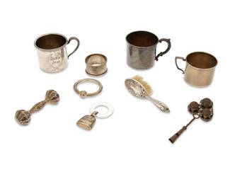 1352
A group of sterling silver and silver-plated baby articles
Late 19th/early 20th century
Four marked for sterling; one rattle marked: Tiffany & Co.; some variously inscribed and personalized
Comprising sterling silver: three rattles, a baby cup, and a napkin ring; silver-plated: two baby cups and a baby hairbrush; together with a brass tripartite rattle
9 pieces
Largest cup: 2.625" H x 3.625" W x 2.5" D
Weighable sterling: 4.7 gross oz. troy
Estimate: $100 - $150