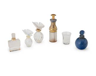 1355
A group of Lalique glass perfume bottles
20th century
Two stenciled: Nina Ricci / Bottle Made By / Lalique / France; one marked in the mold in relief: Molinard / Creation Lalique; atomizer marked: Made in France / R. Lalique; further marked in the metal: F / Le Parisien / Bte. S D G C / Made in France / O / [arrow]; shot glass ectched: Lalique / France
Comprising a Molinard bottle, two Nina Ricci 'L'Air du Temps' bottles, an atomizer, and a 'Dans La Nuit' for Worth bottle, together with a Lalique shot glass
6 pieces
Tallest: 4.75" H; Shot glass: 1.875" H
Estimate: $400 - $600