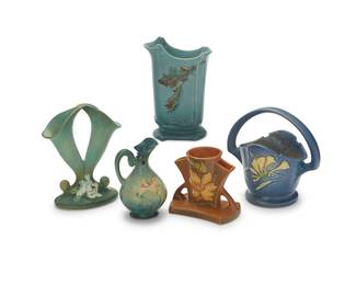 1435
A group of Roseville pottery vases
Early/mid-20th century
Four marked for Roseville and variously numbered: 121-8 / 22-6 / 391-8 / 622-8; one marked: Weller
Comprising a 'Freesia' vase, a 'Zephyr Lily' ewer, a 'Freesia' basket, and a 'Gardenia Cornucopia' bud vase, together with a Weller 'Oak Leaf' vase
5 pieces
Tallest: 8.625" H x 6" W x 3.5" D; Shortest: 6.5" H x 4.25" W x 3.875" D
Estimate: $300 - $400