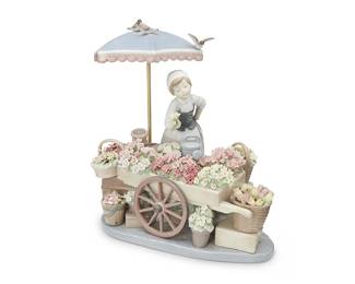 1359
A Lladro porcelain 'Flowers of the Season' figurine
1984
Incised with artist's cipher [conjoined JP]; impressed: 1454; with blue inked stamp: [logo] / Lladró ® / Hand made in Spain / © Daisa / 1984; further marked [trefoil] / C-8 JS
Designed 1983 by Jose Puche, the glazed porcelain scene depicting a girl with a flower cart beneath an umbrella
11" H x 11" W x 7" D
Estimate: $600 - $900