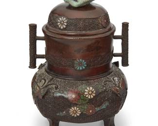 1387
An archaistic champlevé and bronze censer
Meiji Period (1868-1912)
Bearing impressed mark possibly reading: Muraoka Kame zo
Likely Japanese, the footed censer with opposed handles and champlevé enameled floral and butterfly accents, the lid featuring a turquoise finial
7.5" H x 5.5" W x 5.5" D
Estimate: $400 - $600