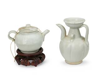 1391
A Chinese yingqing-glazed porcelain pitcher and teapot
Song Dynasty (960-1280)
Comprising a baluster-form handled pitcher with foot, and a handled wine pot, the lid with floral blossom decoration and bound by a loop string knot, raised on a carved wood stand
2 pieces
Pitcher: 5" H x 3.75" W x 3.25" D; Teapot: 3.25" H x 4.625" W x 3.25" D; Stand: 1.625" H x 3.5" Dia.
Estimate: $200 - $300
