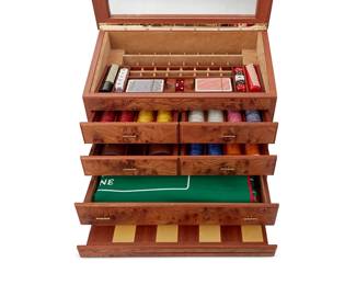 1457
An Agresti briarwood multi-game box
Early 21st Century; Florence, Italy
Felt to underside with Agresti pattern; includes paper playing instructions, information about the wood, and other details
The briarwood case with an upper glazed hinged top and five suede-lined drawers above a pull-out folding chess and backgammon felt board, housing dice, two decks of playing cards, dominos, chips, backgammon/checkers pieces, a felt craps surface, and a chip rake
15.875" H x 18.375" W x 12.875" D
Estimate: $100 - $200
