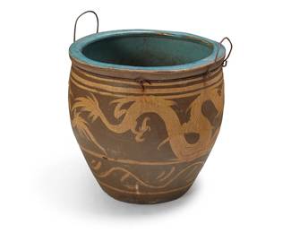 1403
An Asian ceramic jardinière
19th century or later; China or Southeast Asia
The jardinière depicting a dragon figure in ochre and brown glazes, with a teal glazed interior, the rim fitted with a metal ring and opposed handles
Without handles: 19.75" H x 20.5" Dia.
Estimate: $300 - $400
