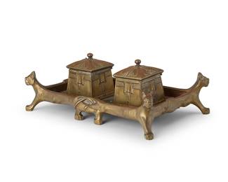 1369
An Austrian Secessionist bronze figural inkwell
Circa 1904
The bronze and copper tray with mammalian forms at the corners, and incised detailing, mounted with two bronze lidded architectural compartments, one housing a ceramic well
4.25" H x 12.25" W x 7.5" D
Estimate: $200 - $300
