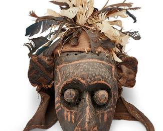 1461
A Congolese carved wood dance mask
20th century, Kuba Bushoong; Democratic Republic of the Congo
The ceremonial mask with painted accents and protruding eyes centering perforated sight holes, mounted with feathers and fabric
18" H x 12" W x 12" D approximately
Estimate: $200 - $400