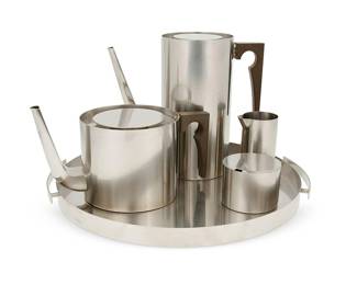 1486
Arne Jacobsen (1902-1971)
A stainless steel 'Cylinda Line' tea and coffee service for Stelton, mid-20th century
Designed 1967
Each marked to underside: Stelton / Stainless / Denmark; tray additionally marked: AJ
Comprising a teapot (5.125" H x 9.375" W x 5.125" D) and coffee pot (8" H x 9" W x 4.125" D), each with composite handle, an open creamer (3.75" H x 2.375" W x 2" D), and a lidded sugar (2.25" H x 3" Dia.), set on a handled tray (1" H x 14.125" W x 13.25" D)
5 pieces
Estimate: $300 - $500