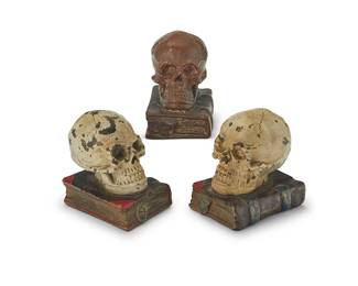 1446
Three bronzed plaster skull-form bookends
20th century
Each depicting a skull above a book
3 pieces
Each: 5.5" H x 5.5" W x 4" D approx.
Estimate: $100 - $150