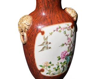 1386
A Chinese faux bois porcelain baluster vase
Late Qing Republic (late 19th/early 20th century)
Bearing blue underglaze seal to underside
Centering reserves of flowering branches and birds on a white ground flanked by gilt lion mask ring handles
7.5" H x 4.75" W x 3.25" D
Estimate: $800 - $1,200