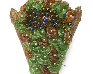 1452
A Venetian glass-mounted metal sconce
20th century
The copper alloy sconce with mesh wire backing mounted with glass grape-form accents
11" H x 9.25" W x 4" D
Estimate: $50 - $100