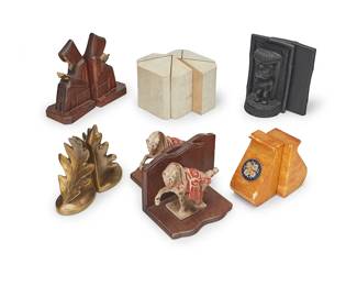 1438
Six pairs of book ends
20th century
Tiki marked to underside: Made with Lava by CoCo Joe / ©68 / #292 / Made in Hawaii
Comprising lava rock and resin Tiki god figures, painted metal horses on wood, metal leaf-forms, carved wood hooded figures, enamel-mounted yellow hardstones, and stone-mounted wood architectural
12 pieces
Tallest: 8.25" H x 5.375" W x 3.125" D; Shortest: 5.625" H x 2.75" W x 3.25" D
Estimate: $100 - $150
