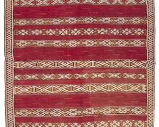 1424
A large North African embroidered woven textile
20th century, likely North African/Bedouin
Woven in red wool featuring multiple bands of white and multicolored cotton and wool geometric embroidery, with geometric borders to long side edges and fringing to one end
10' L x 5' 9" W
Estimate: $200 - $400