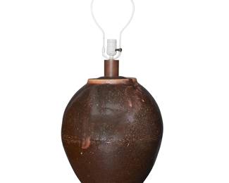 1407
A Japanese glazed stoneware jar converted lamp
18th/19th century with later elements
Possibly Tokoname pottery or tamba ware, the earthenware round jar fitted with a wood base and single-light lamp components, electrified
Overall without harp: 23.75" H x 14" Dia.
Estimate: $300 - $500