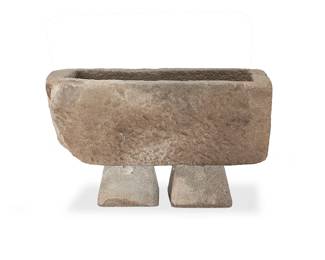 1371
A stone garden planter
20th/early 21st century
The planter with rough-hewn edges, set on two associated stone bases
3 pieces
Planter: 15" H x 34.5" W x 15.5" D; Each base: 7.25" H x 11" W x 11" D
Estimate: $300 - $500