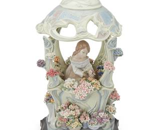 1360
A Lladro porcelain 'Gazebo in Bloom' figurine
2000
From the edition of 2,000
Impressed: 1865; with blue inked stamp: [logo] / Lladró ® / Hand made in Spain / © Daisa / 2000; signed and numbered: Escul. Fr. Polope / No 1844 / Decor: Angeles Cabo
Sculpted by Francisco Polope and decorated by Angeles Cabo, the glazed porcelain scene depicting a woman placing flowers in a gazebo, set on a wood pedestal
Porcelain: 19" H x 9" W x 9.5" D; Overall: 20.125" H x 9.75" W x 9.75" D
Estimate: $600 - $900