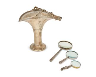 1347
Three English sterling silver magnifying glasses and a wedding basket
Late 19th/early 20th century
Basket and each magnifying glass handle marked for sterling; basket with Meriden Britannia Company (Connecticut) logo and numbered: 1238 1/2 A; handles with British hallmarks for various makers; one glass band spuriously marked: German Silver
Comprising three magnifying glasses with chased and repoussé scrolled motifs to handles, and a handled wedding basket with pierced rim, personalized
4 pieces
Basket stored: 12.75" H x 12.75" W x 8" D; Largest magnifying glass: 12.25" L
Weighable sterling: 28 oz. troy approximately
Estimate: $300 - $500
