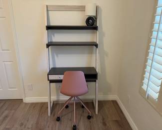 Wayfair bookshelf and wall desk, 34" l x 15" w x 71" h. Article pink swivel chair. Small desk lamp, black circle with white shade.