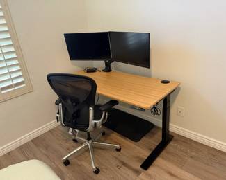 Fuly electic standing desk, Herman Miller chair, Two black 28" Asus LCD monitors (2), Fuly dual monitor mount to attach to standing desk.